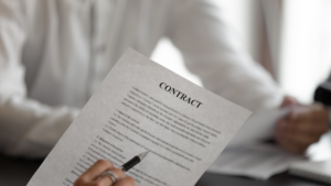 Professional reviews a contract document while evaluating task order requirements - BIT Solutions LLC Professional reviews a contract document while evaluating task order requirements