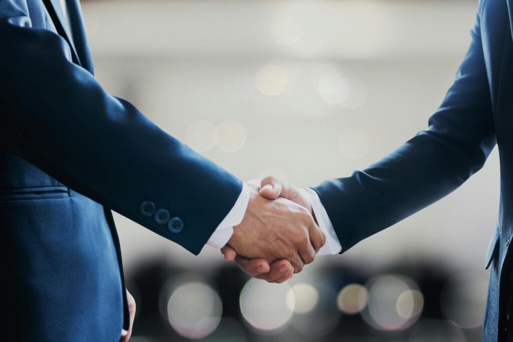 Government contractor shaking hands winning bid